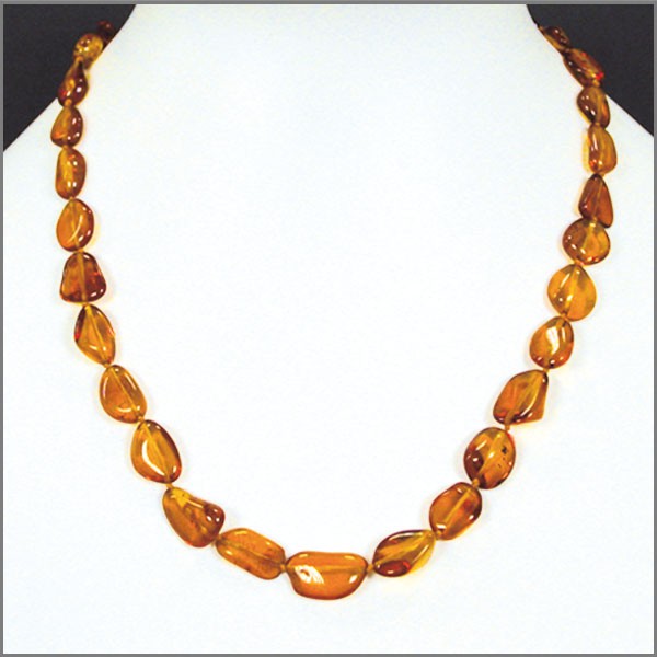 Cognac-colored amber, free-form, natural beads measuring 15 to 20 millimeters, sold in a 45 to 50 centimeter necklace. Amber screw clasp system. AA to AAA quality, superb beads, lightweight and incredibly soft!