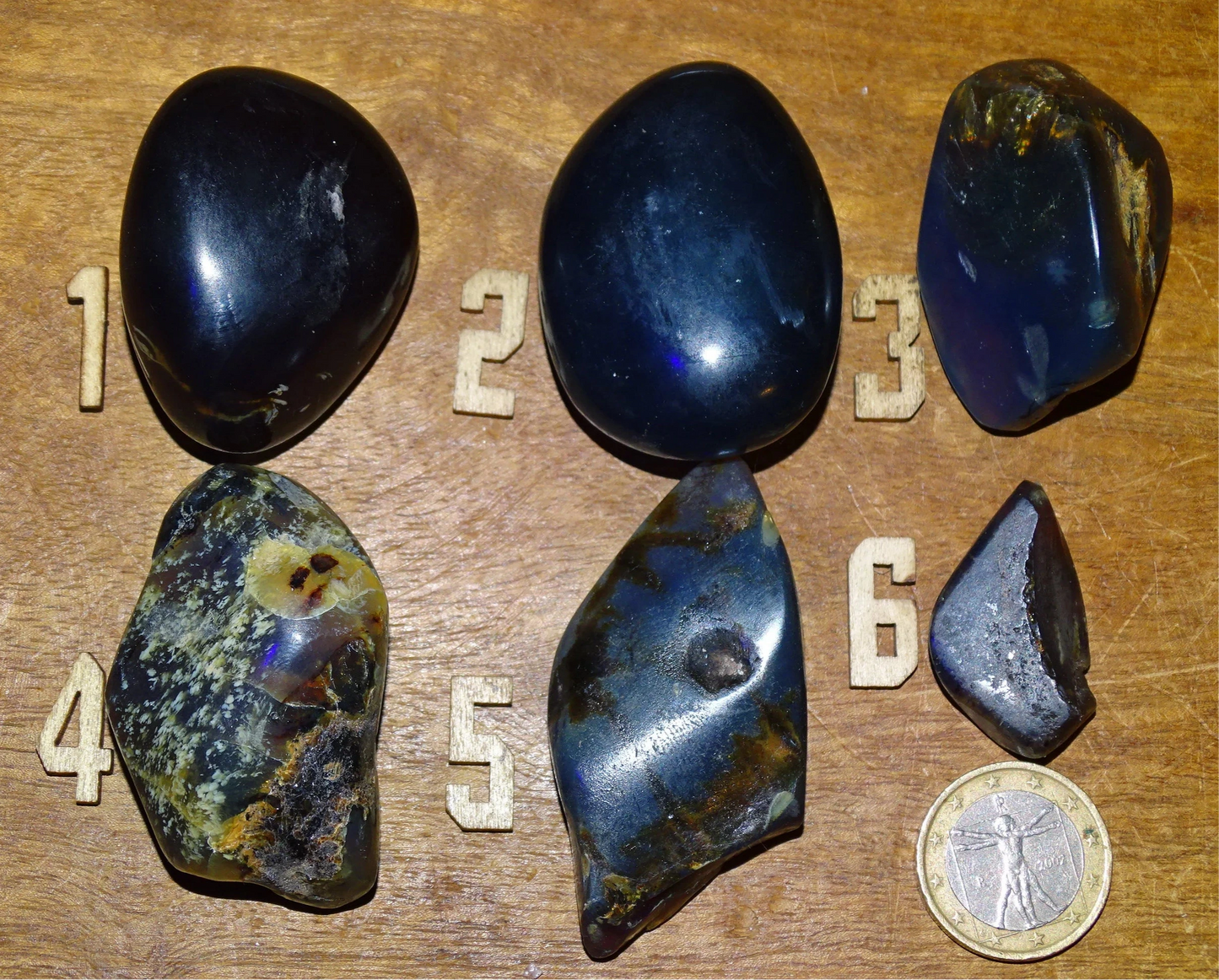 Sumatran blue amber, a selection of polished pebbles, 'cherry/cognac amber' color. Very high quality, when transparent you will see incredible amber red reflections and a captivating blue under a UV lamp!