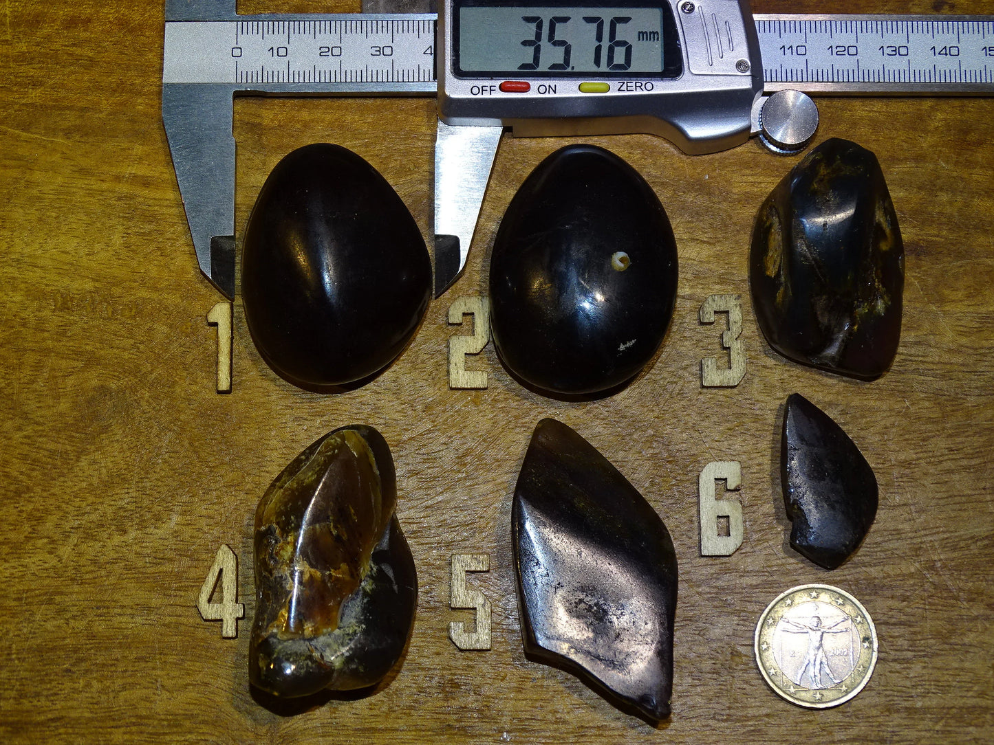 Sumatran blue amber, a selection of polished pebbles, 'cherry/cognac amber' color. Very high quality, when transparent you will see incredible amber red reflections and a captivating blue under a UV lamp!