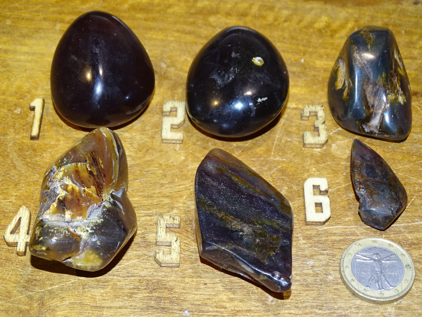 Sumatran blue amber, a selection of polished pebbles, 'cherry/cognac amber' color. Very high quality, when transparent you will see incredible amber red reflections and a captivating blue under a UV lamp!