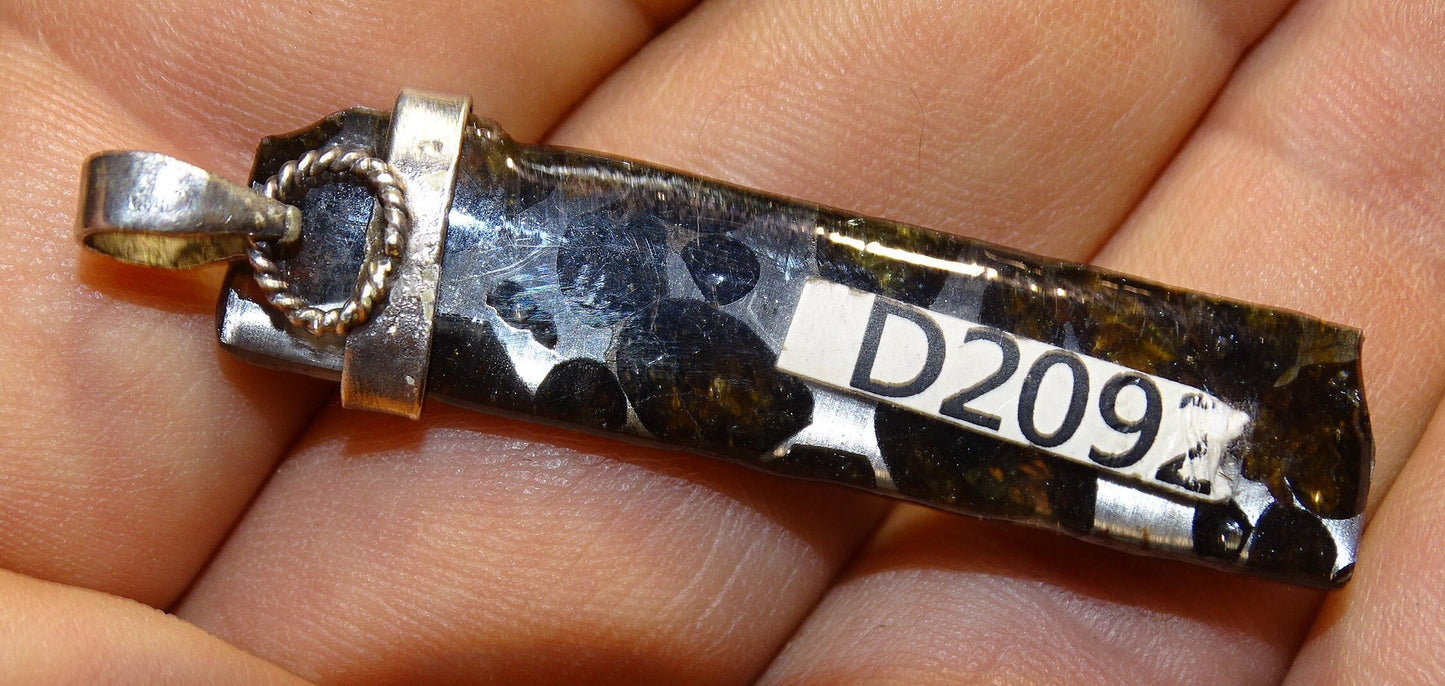 Météorites Pallasites Sericho, pendentif en Argent de 5 gr., 50 x 12 x 5 mm. Piéce rare et se distingue par la présence de gros cristaux d'olivine (péridot) en inclusion !