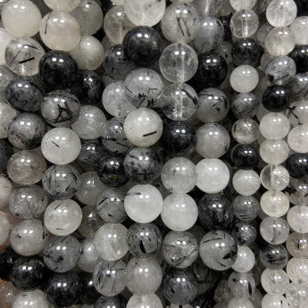 Tourmaline Noire avec Quartz de qualité, perles rondes de 6 et 8 mm, vendu en : fil de perle 38/39 cm, en bracelet de 17 à 21cm, en collier de 45 ou sautoir de 60cm. Qualité AA à AAA, superbes perles naturellement cristalline !
